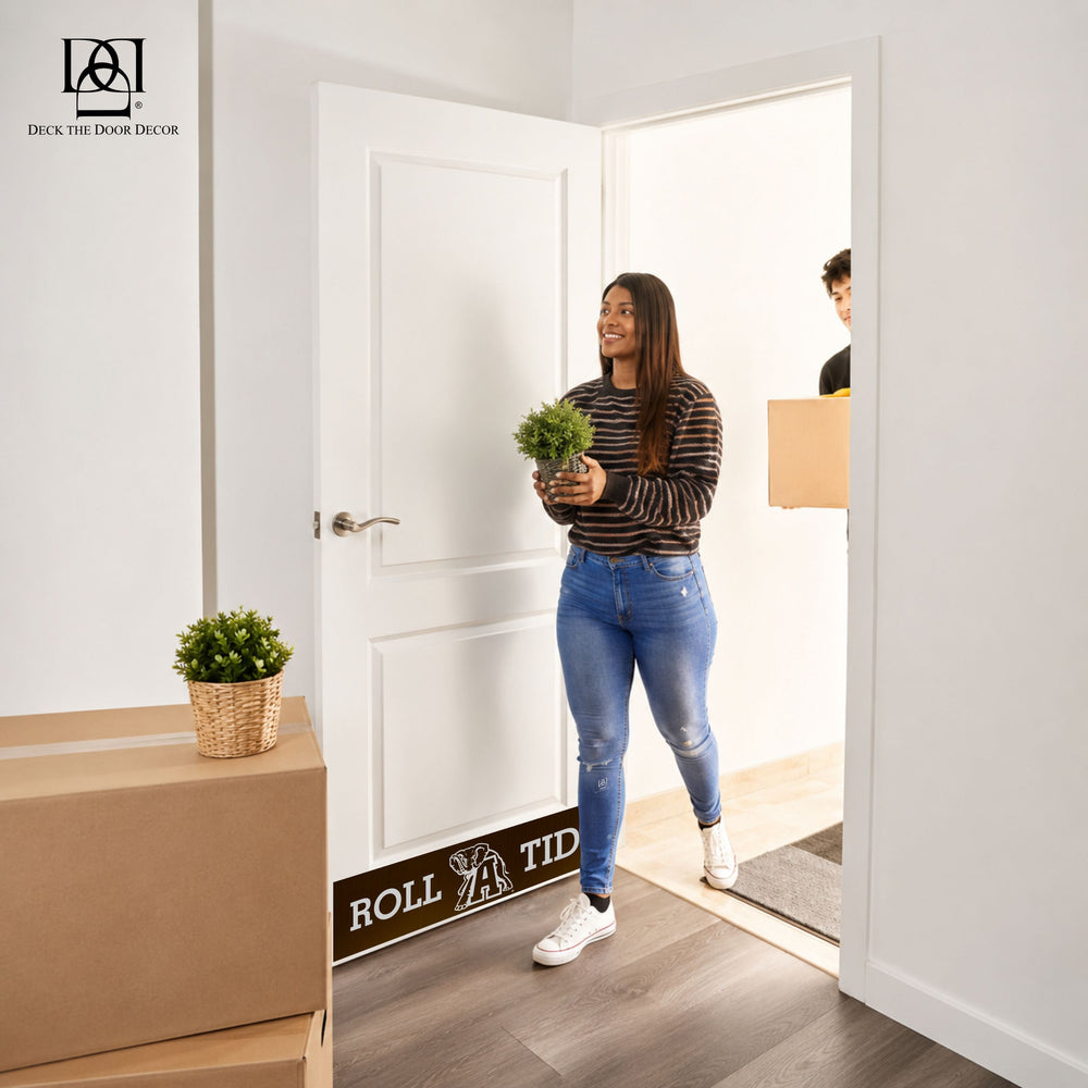 Woman entering a home with Alabama Roll Tide door kick plate holding a plant.
