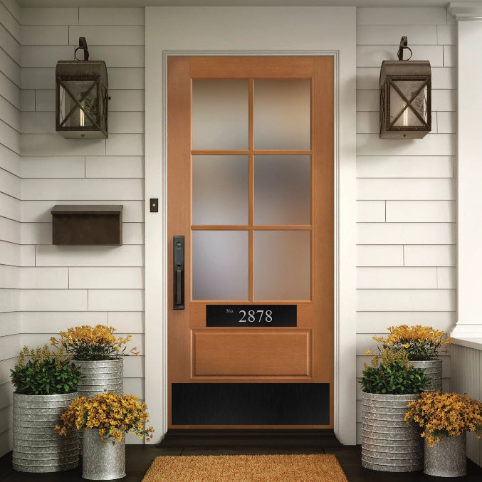 Wood front door with black door plate and black address accent plate engraved