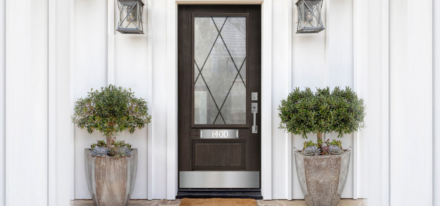 Dark wood door with nickel hardware and engraved address accent plate