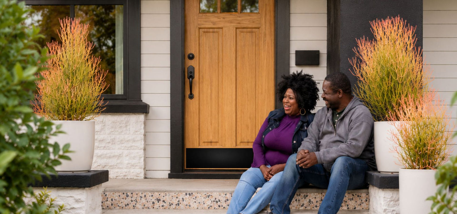 couple by wood door with satin black door kick plate