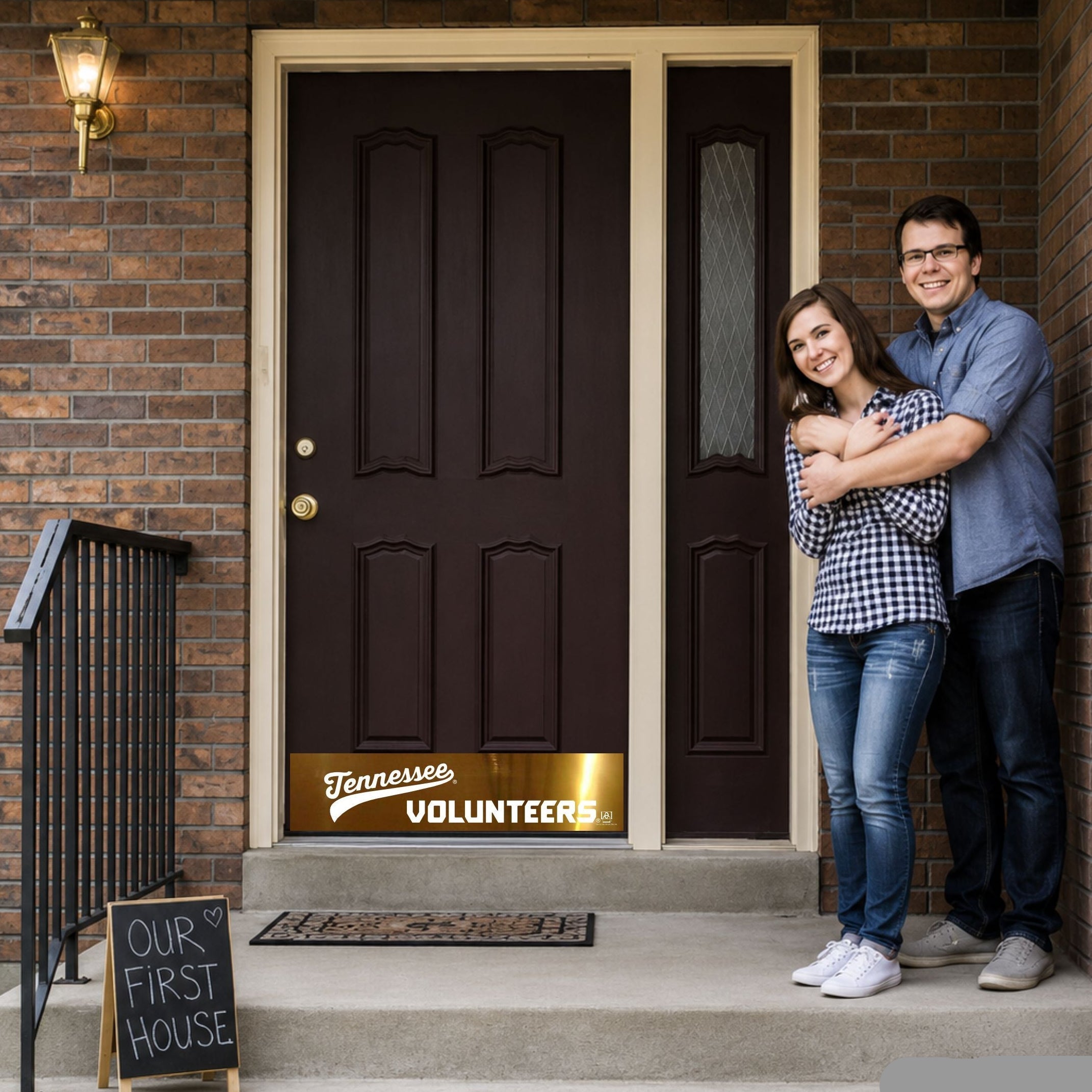 Young couple at new home front door with Tennessee Volunteers Door Kick Plate
